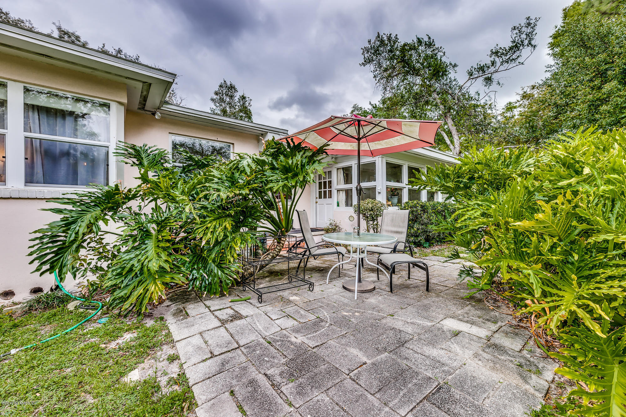 6403 Wesleyan Road Jacksonville, FL 32217 - Photo 11 of 37 a view of a patio with table and chairs under an umbrella
