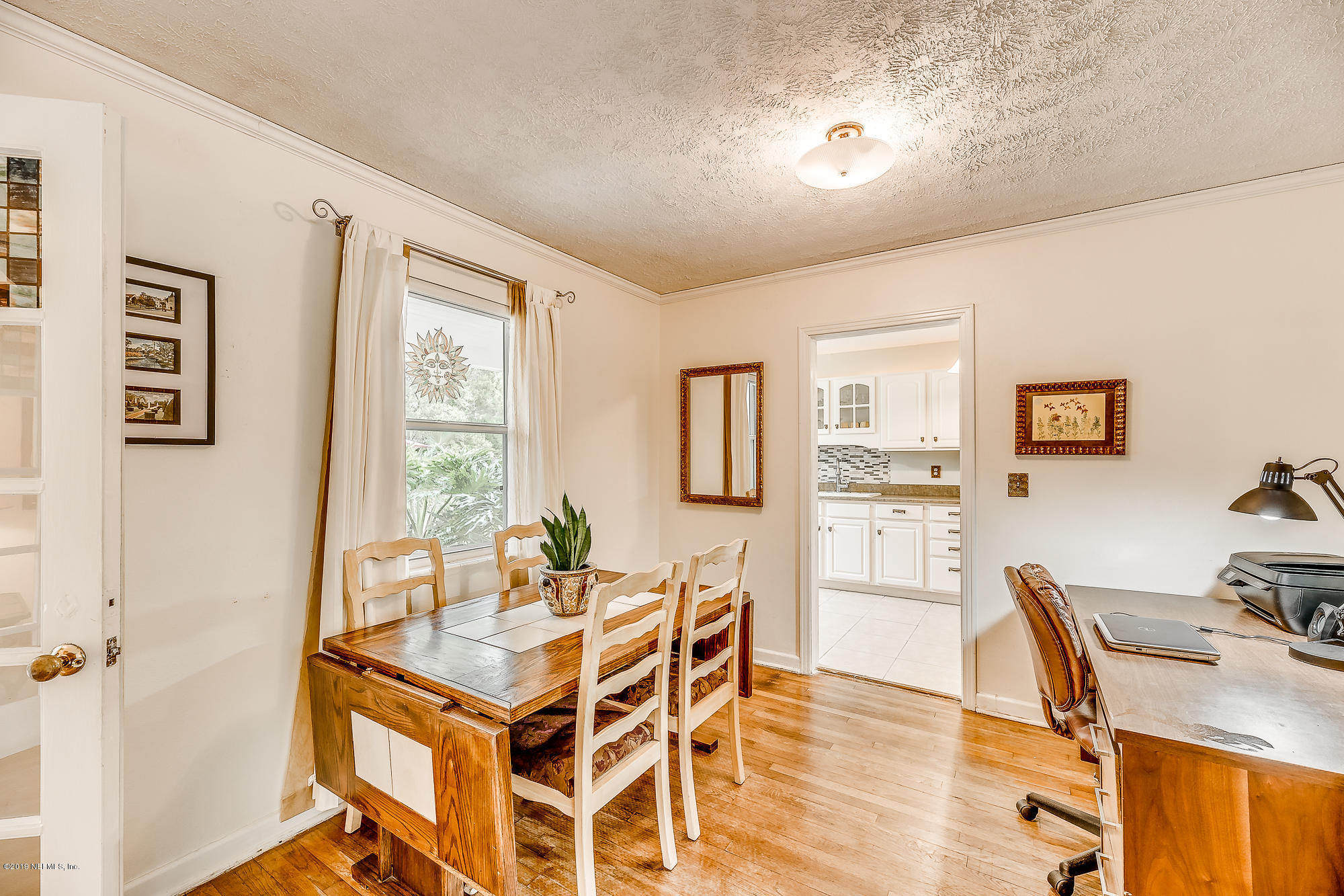6403 Wesleyan Road Jacksonville, FL 32217 - Photo 20 of 37 a dining room with wooden floor and large window