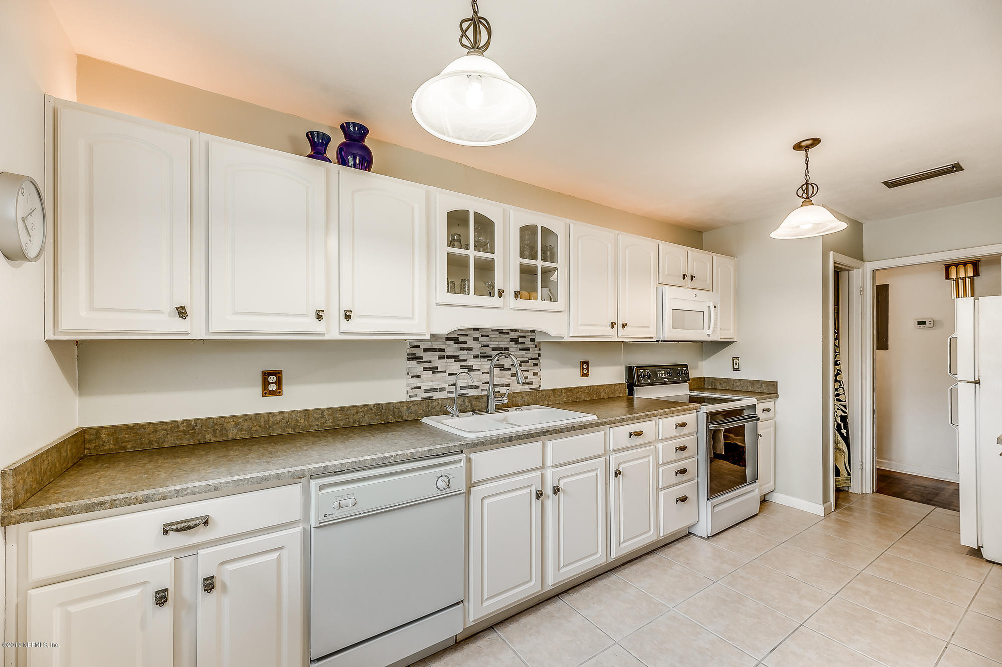 6403 Wesleyan Road Jacksonville, FL 32217 - Photo 26 of 37 a kitchen with a sink dishwasher and cabinets