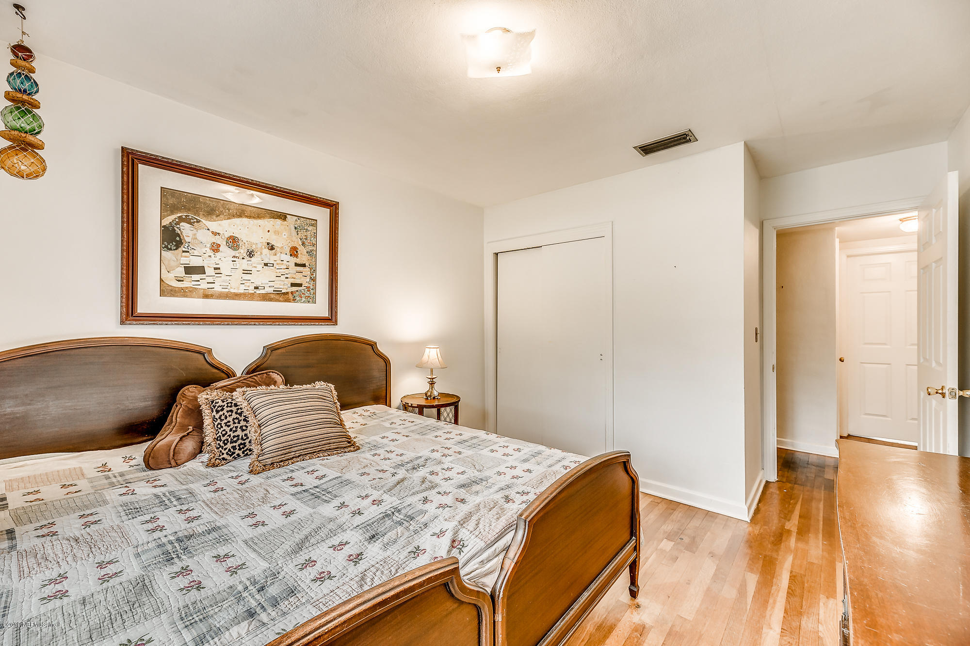 6403 Wesleyan Road Jacksonville, FL 32217 - Photo 29 of 37 a bedroom with a bed and a painting on the wall