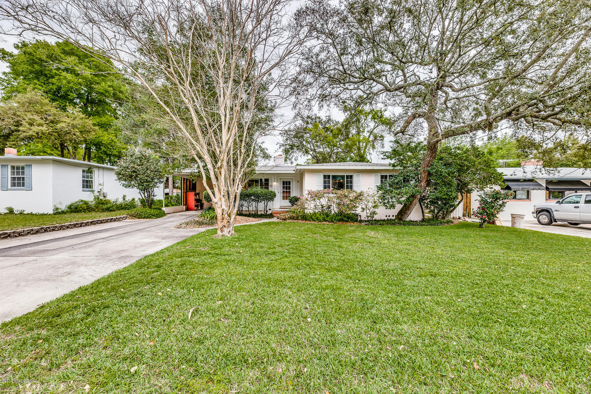 6403 Wesleyan Road Jacksonville, FL 32217 - Photo 3 of 37 a view of house with yard and trees in the background