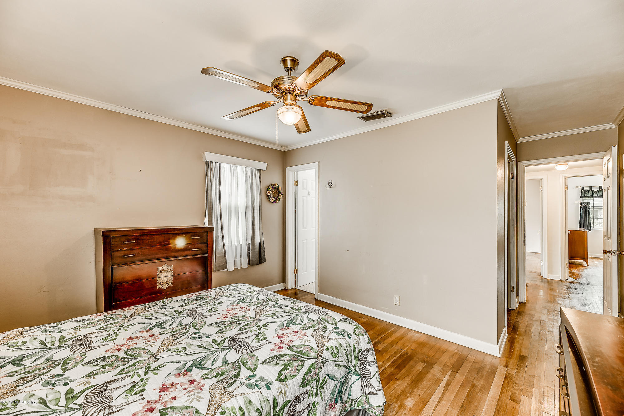 6403 Wesleyan Road Jacksonville, FL 32217 - Photo 34 of 37 a bedroom with a bed and a chandelier
