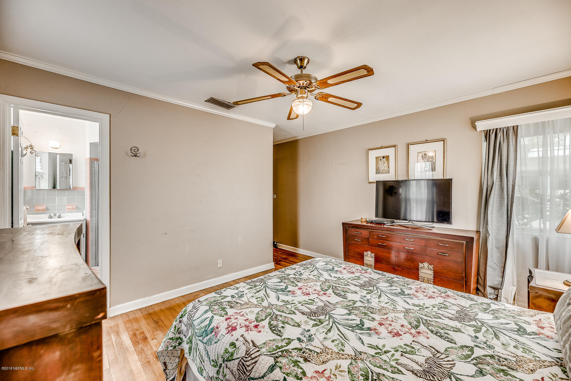 6403 Wesleyan Road Jacksonville, FL 32217 - Photo 35 of 37 a bedroom with a bed and a flat screen tv