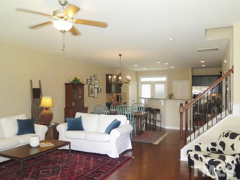 1314 Regulator Street Raleigh, NC 27603 - Photo 2 of 22 a living room with furniture and a chandelier