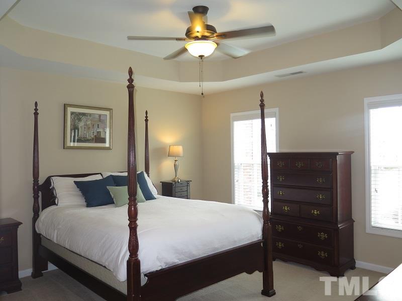 1314 Regulator Street Raleigh, NC 27603 - Photo 12 of 22 a bedroom with a bed and a dresser