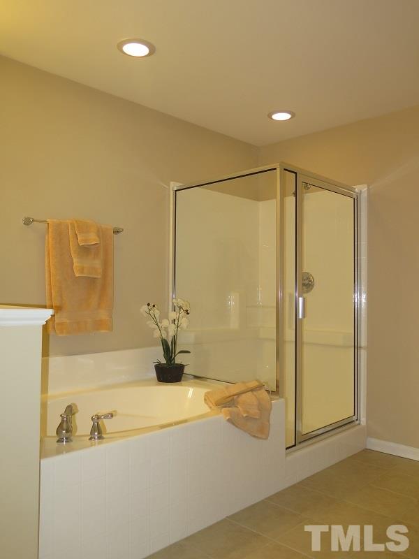 1314 Regulator Street Raleigh, NC 27603 - Photo 13 of 22 a bathroom with a bathtub and a shower