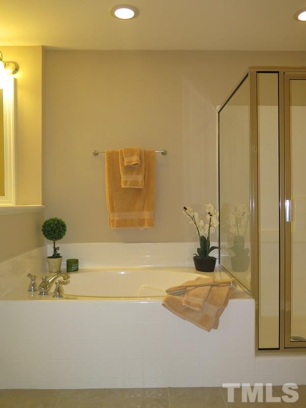 1314 Regulator Street Raleigh, NC 27603 - Photo 14 of 22 a bathroom with a bathtub and a sink