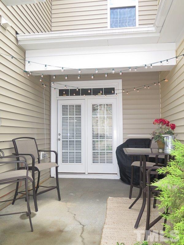1314 Regulator Street Raleigh, NC 27603 - Photo 19 of 22 a balcony with table and chairs and a barbeque