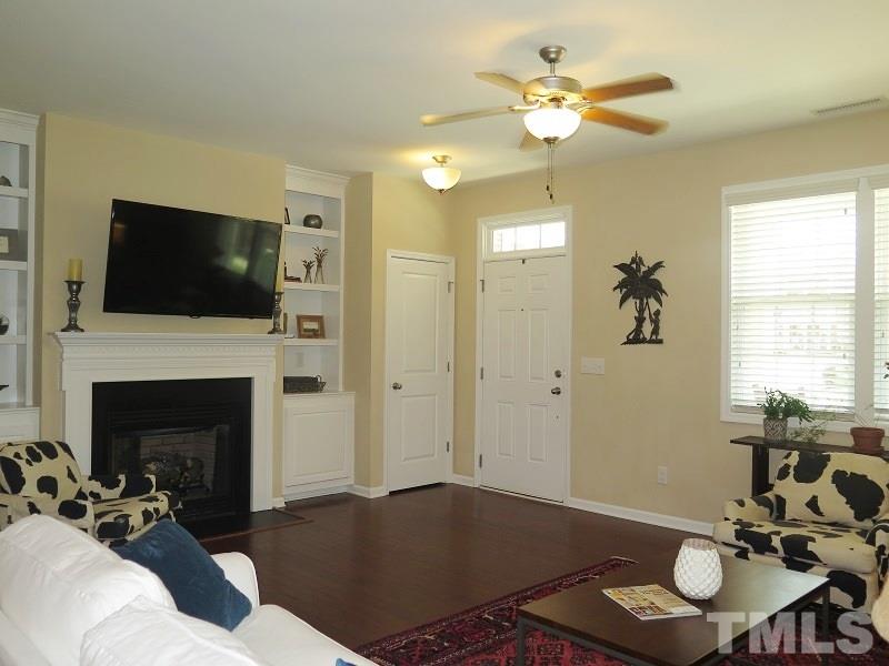 1314 Regulator Street Raleigh, NC 27603 - Photo 4 of 22 a living room with furniture a fireplace and a flat screen tv