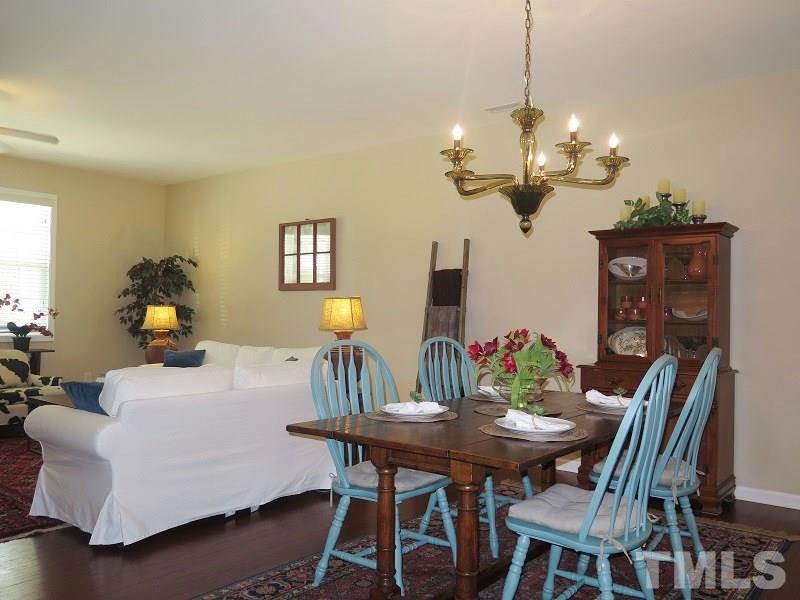 1314 Regulator Street Raleigh, NC 27603 - Photo 5 of 22 a view of a dining room with furniture and chandelier