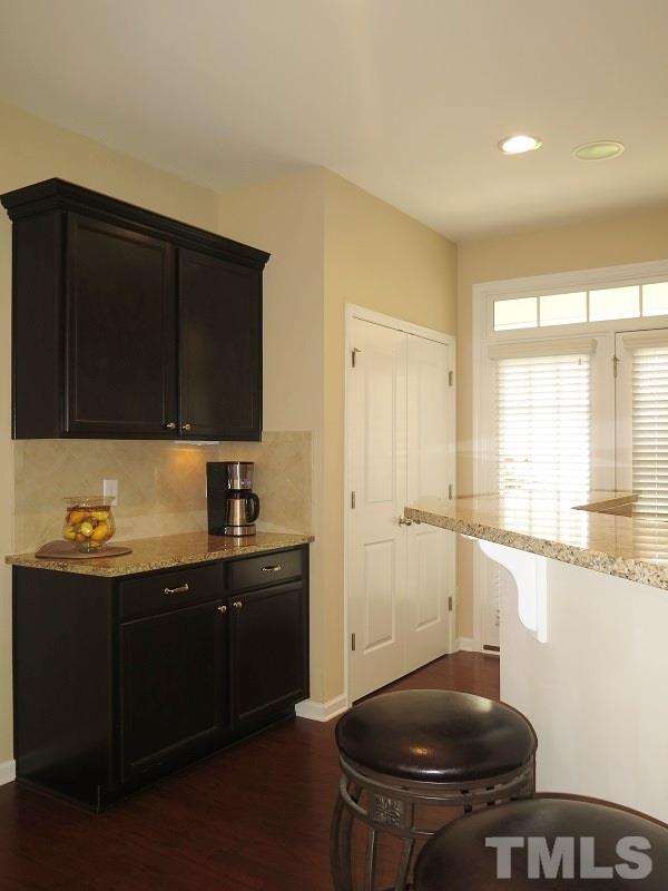 1314 Regulator Street Raleigh, NC 27603 - Photo 10 of 22 a kitchen with granite countertop a sink and a stove