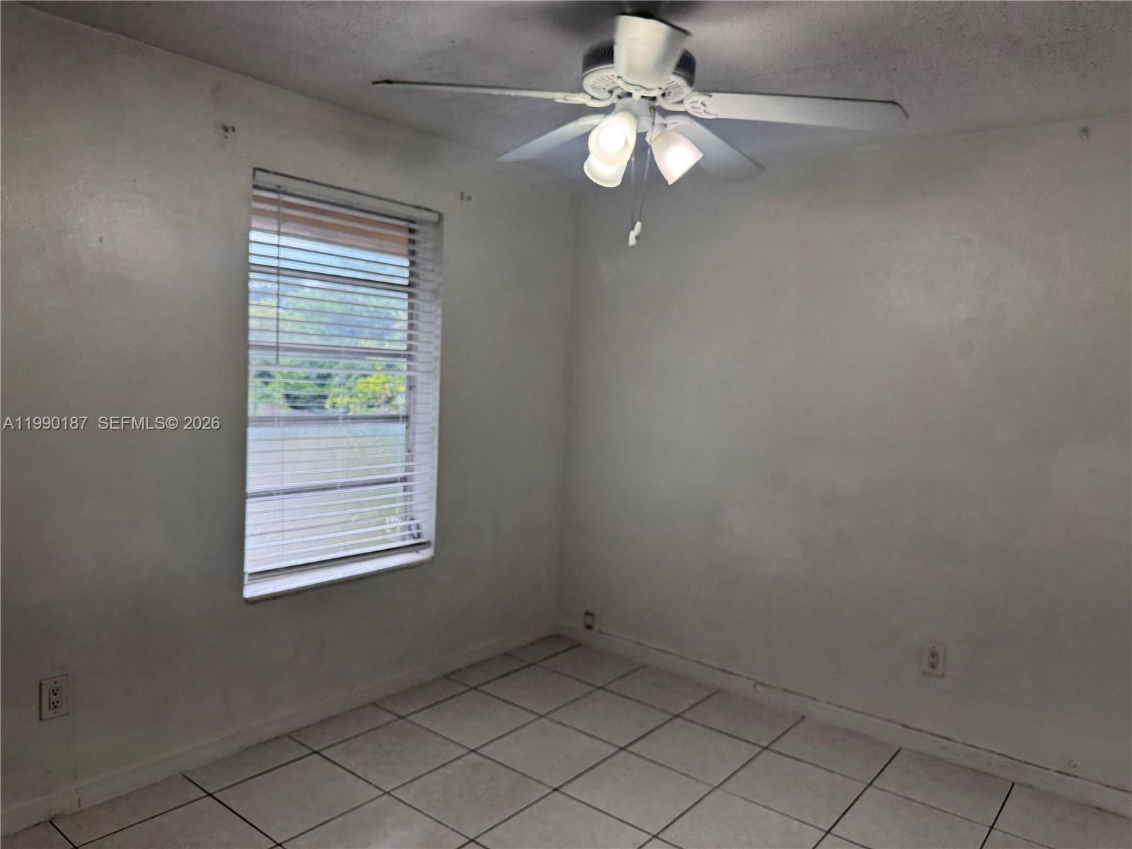 11 Southwest 32nd Avenue, Unit 4 Miami, FL 33135 - Photo 11 of 13 an empty room with windows and fan