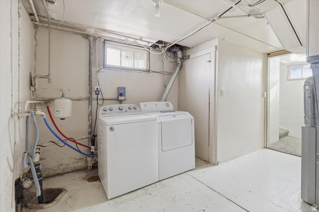 744 North 500 East Logan, UT 84321 - Photo 16 of 29 Laundry area and storage areafeaturing unfinished concrete floors and washing machine and clothes dryer