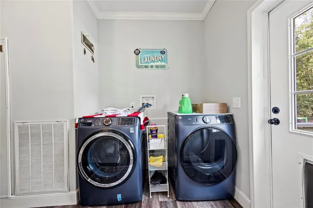 a living room with furniture a flat screen tv and a window