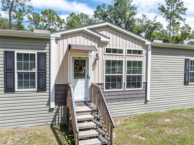 a view of a house with backyard porch and sitting area