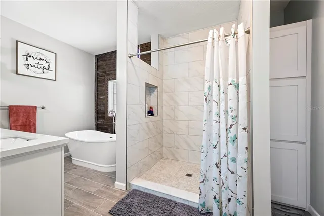 a view of a patio with a table chairs potted plants with wooden floor and fence