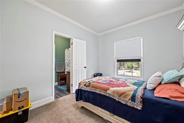 a view of a backyard with a patio and wooden fence