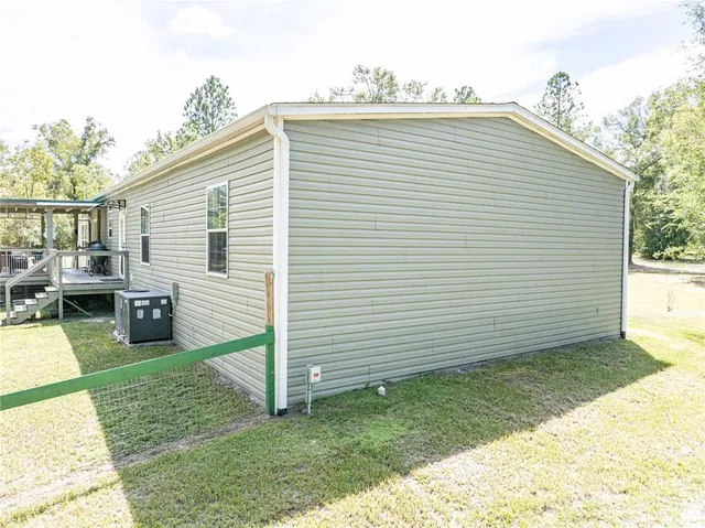 a view of a forest with trees in the background