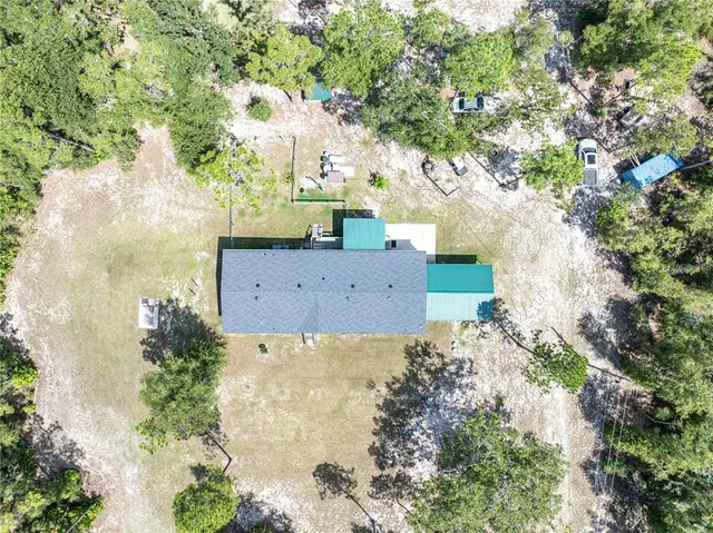 a living room with furniture a flat screen tv and kitchen view