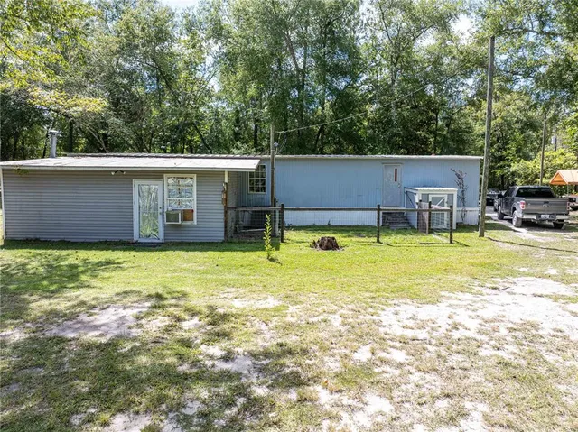 a view of a table and chairs in the yard