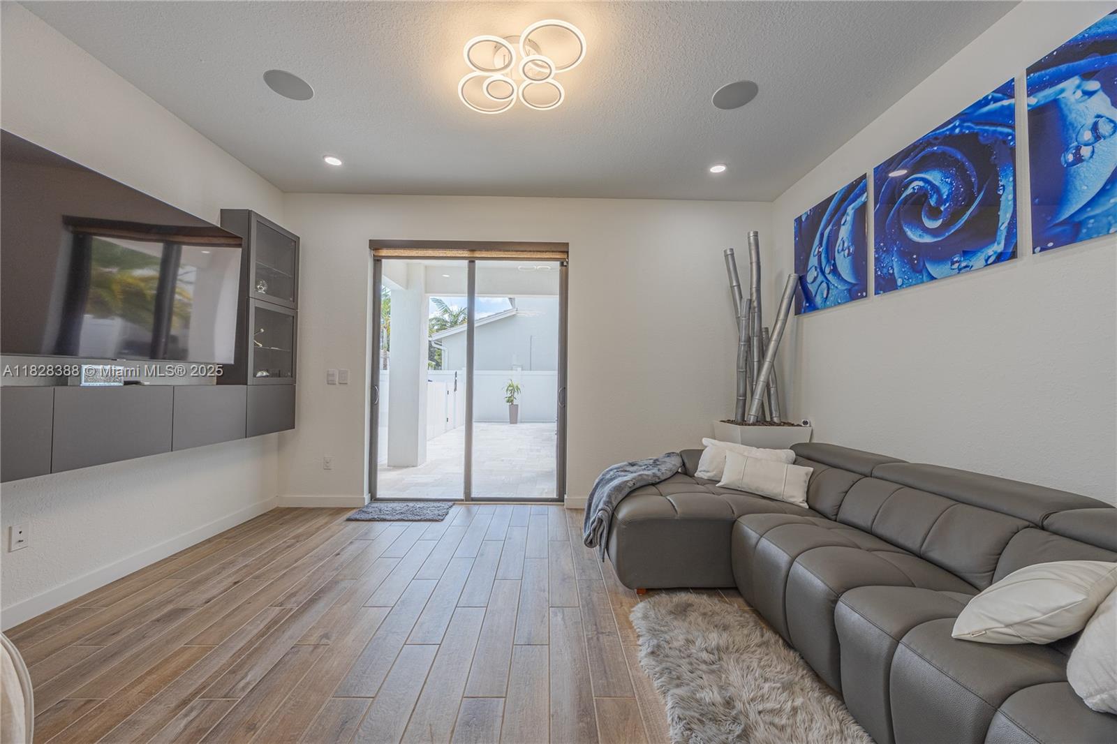 7126 Rockwood Road Jupiter, FL 33458 - Photo 11 of 30 a living room with furniture and a flat screen tv