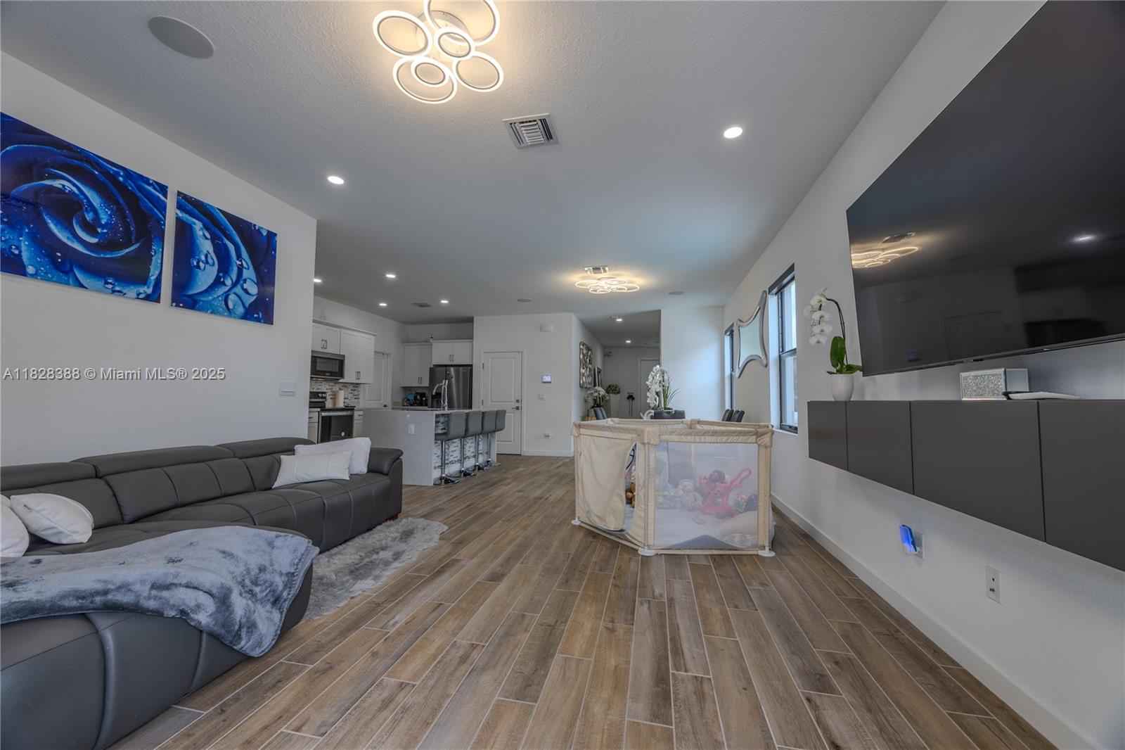 7126 Rockwood Road Jupiter, FL 33458 - Photo 12 of 30 a large living room with stainless steel appliances furniture a rug and a large window