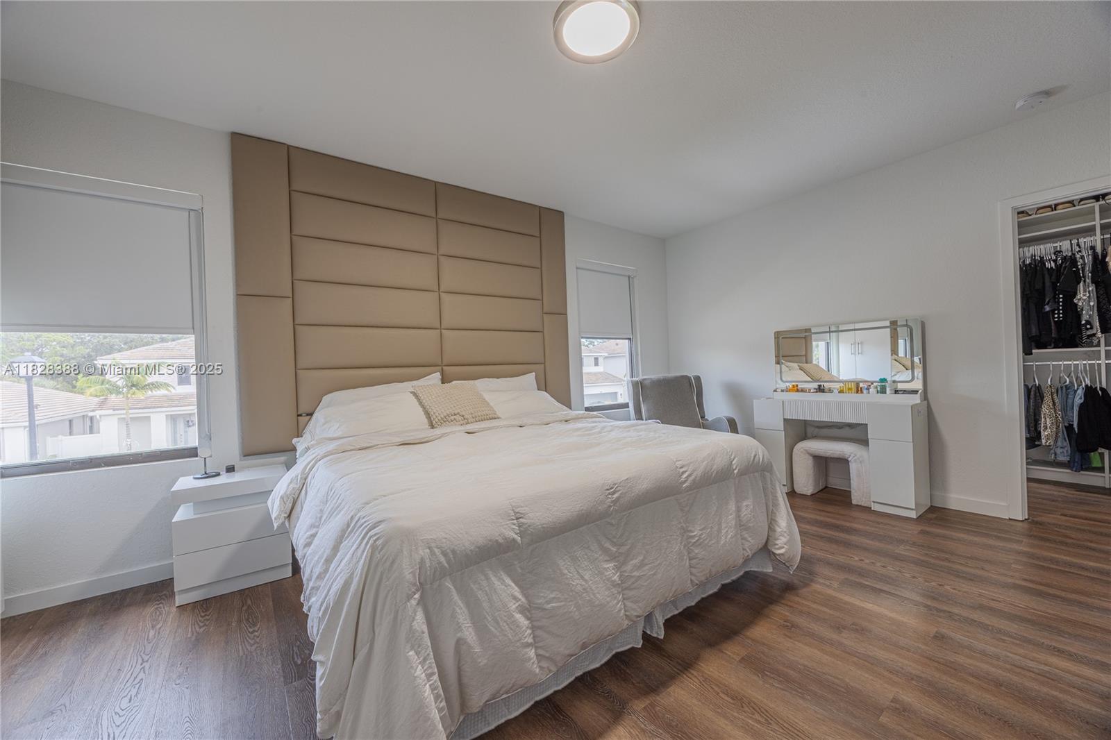 7126 Rockwood Road Jupiter, FL 33458 - Photo 22 of 30 a bedroom with a bed and wooden floor