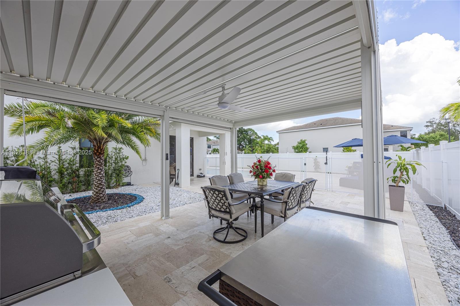 7126 Rockwood Road Jupiter, FL 33458 - Photo 26 of 30 a view of a patio with chairs and table in patio