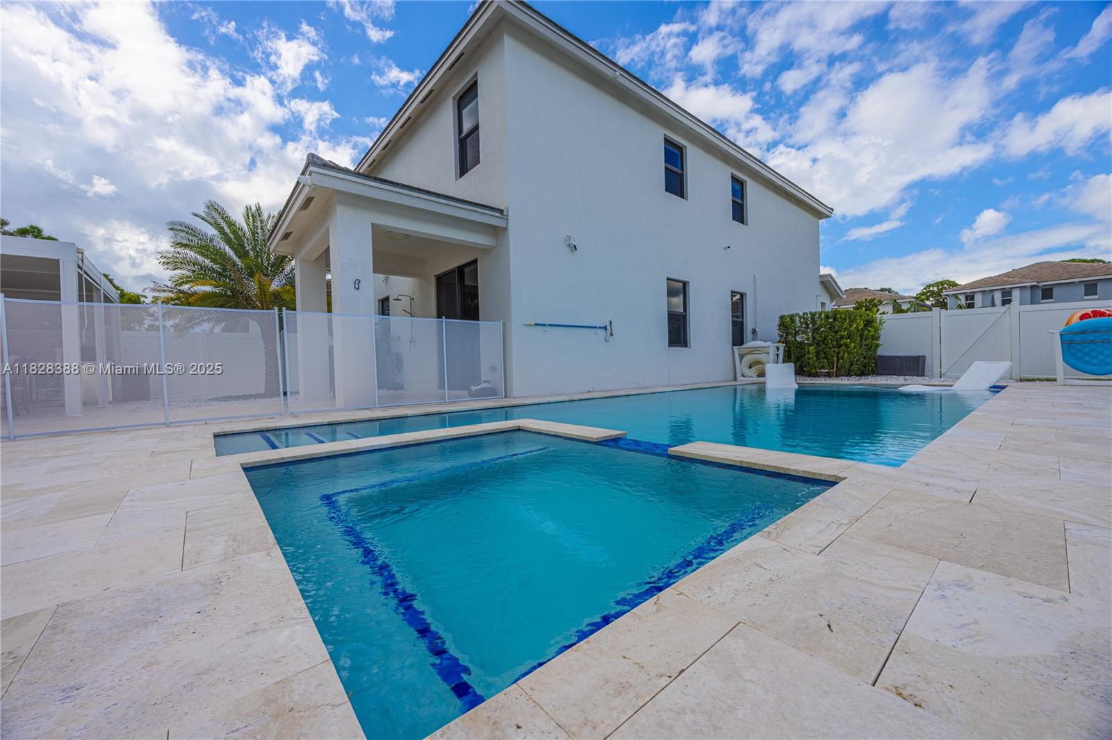 7126 Rockwood Road Jupiter, FL 33458 - Photo 28 of 30 a view of a house with a backyard and a patio
