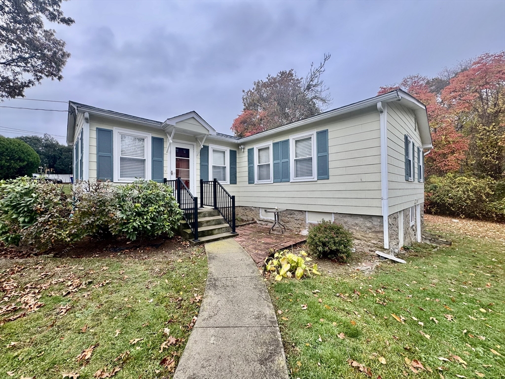16 Winona Avenue Fairhaven, MA 02719 - Photo 1 of 22 a front view of a house with a yard and potted plants