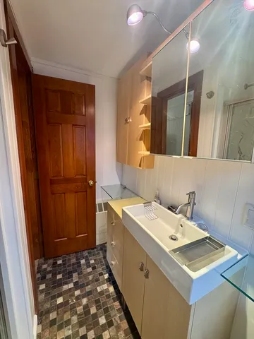 a bathroom with a sink and a mirror