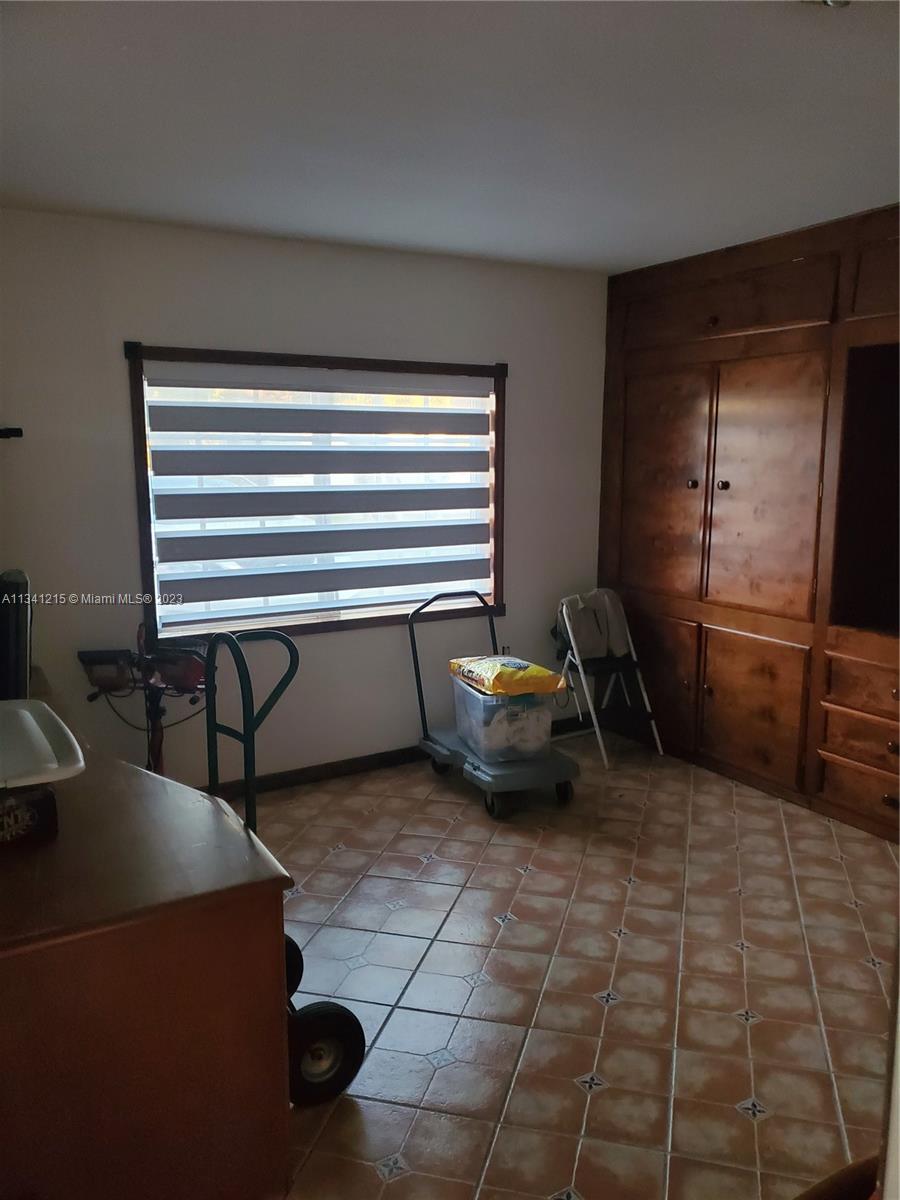 2120 Southwest 84th Avenue Miami, FL 33155 - Photo 4 of 8 a view of a room with chairs and a refrigerator