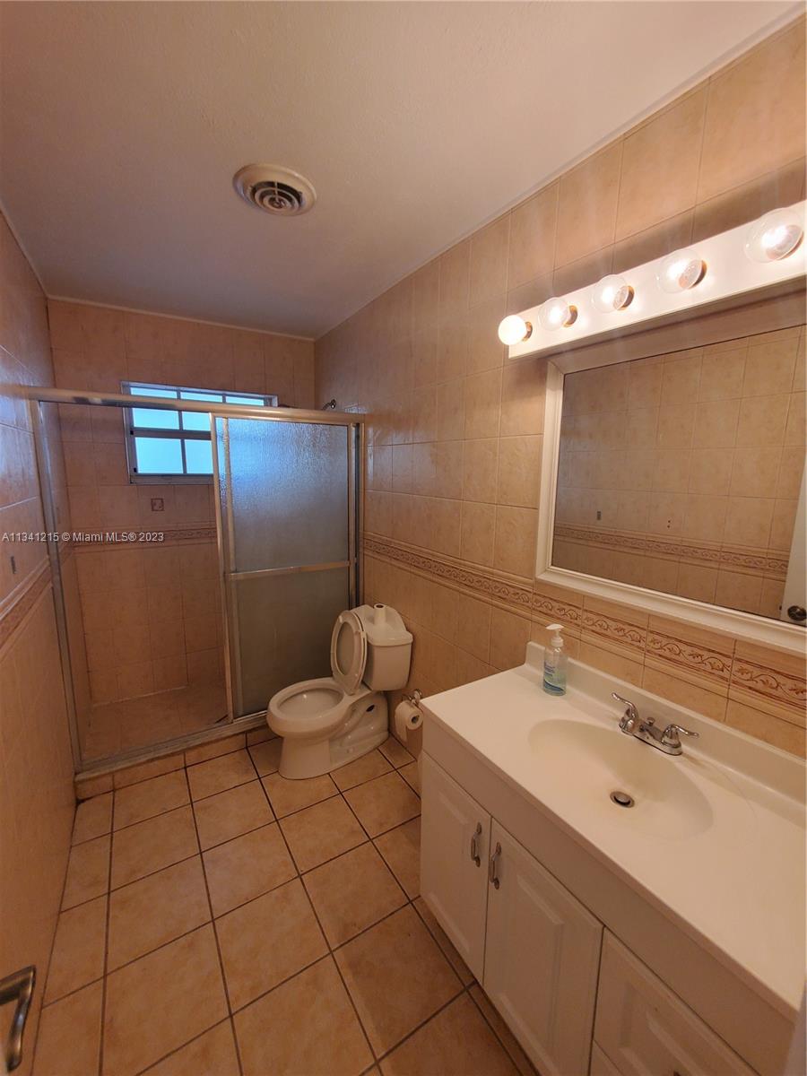 2120 Southwest 84th Avenue Miami, FL 33155 - Photo 5 of 8 a bathroom with a double vanity sink a mirror and a shower