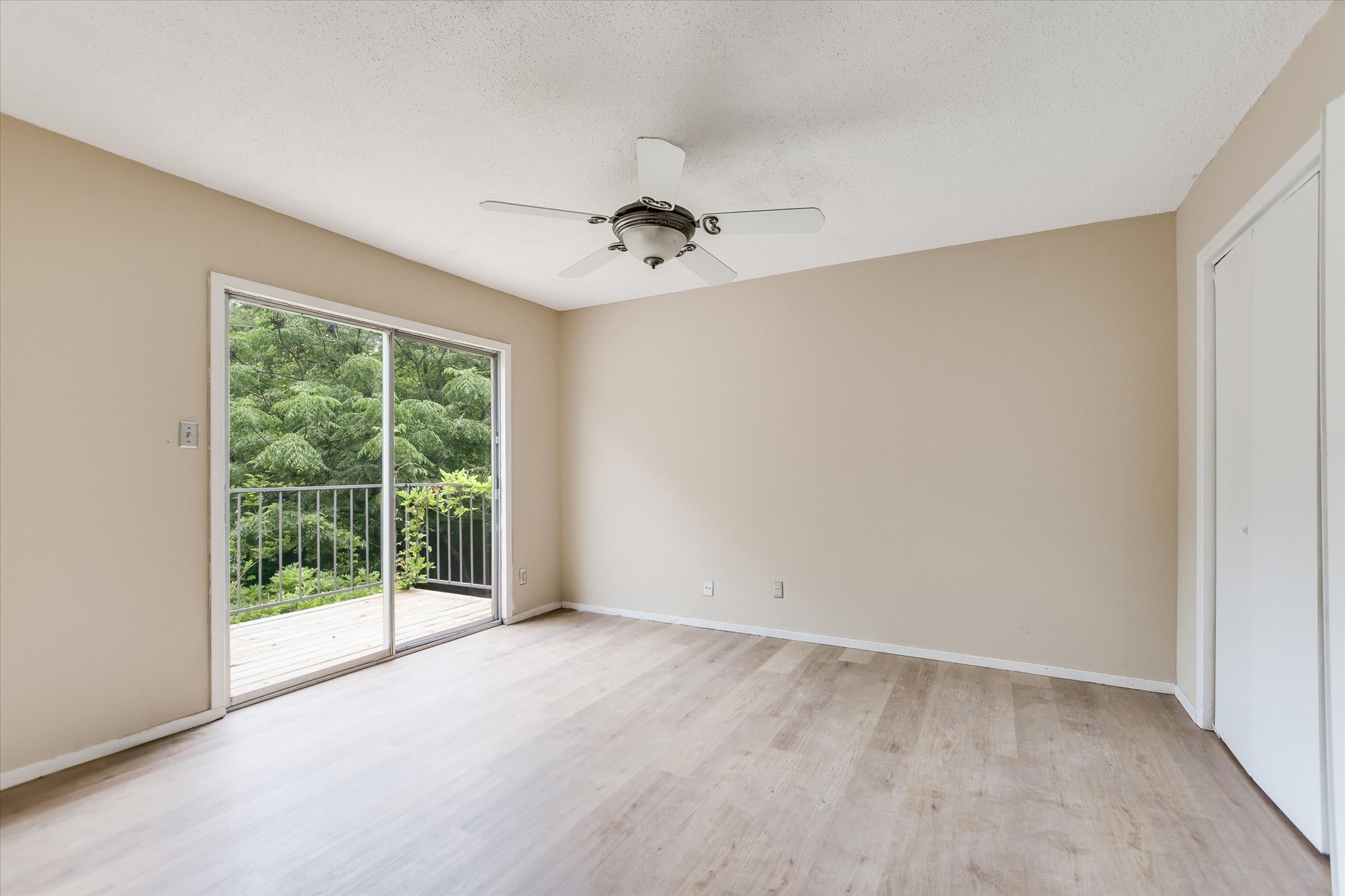 700 Castle Ridge Road, Unit C Austin, TX 78746 - Photo 6 of 10 wooden floor in an empty room with a window