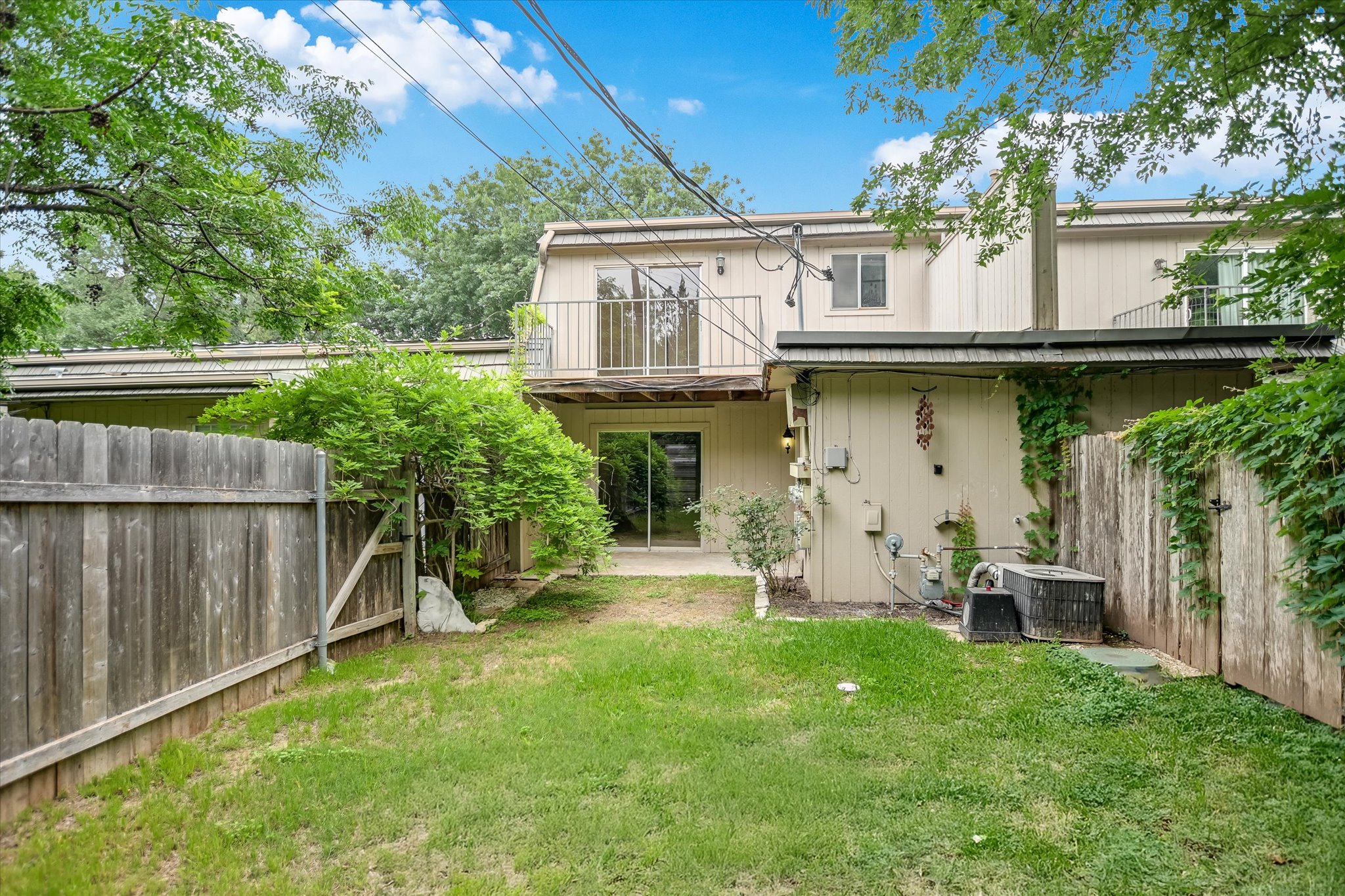 700 Castle Ridge Road, Unit C Austin, TX 78746 - Photo 10 of 10 a view of a house with backyard and a tree