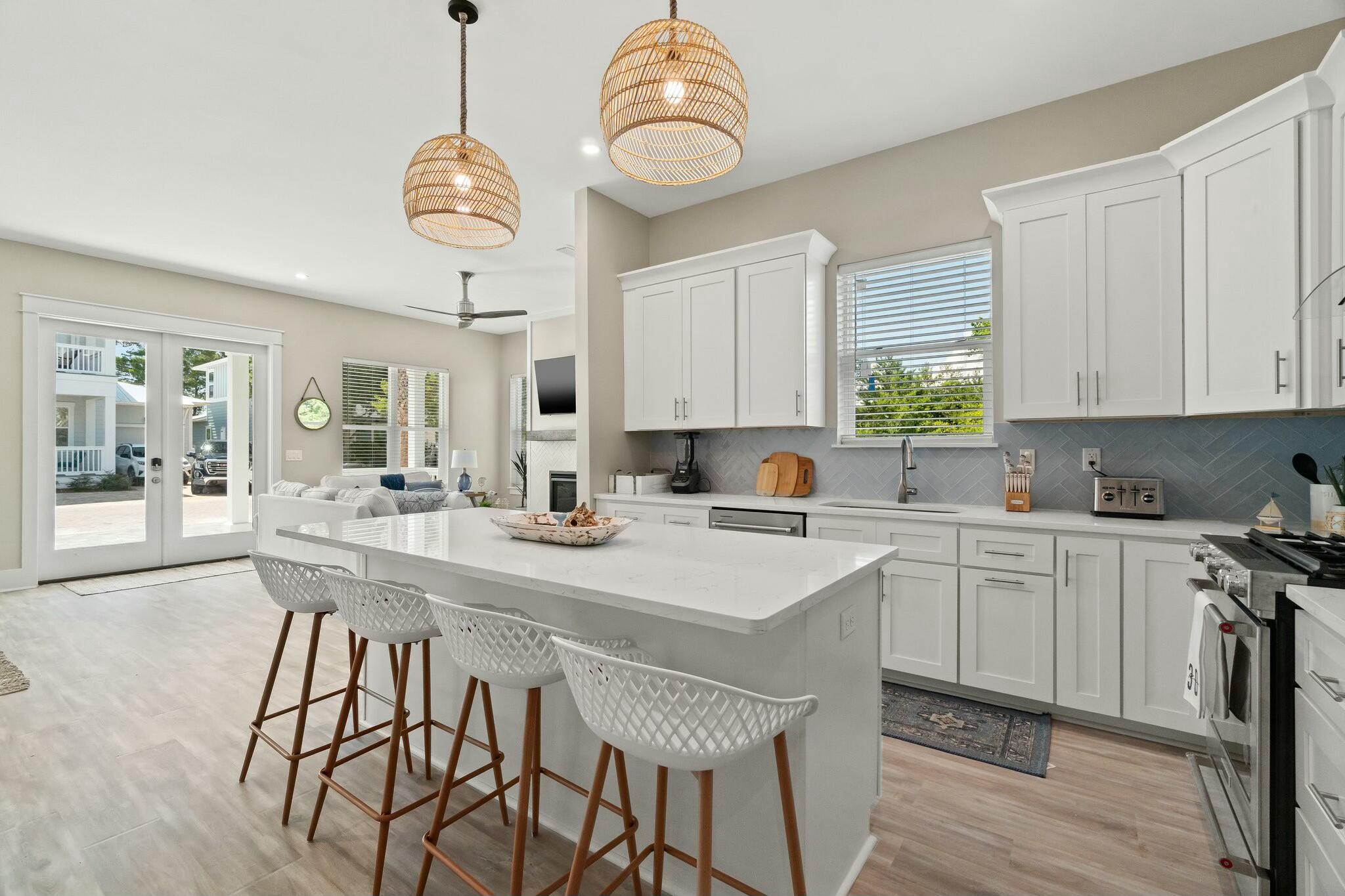 566 Gulfview Circle Santa Rosa Beach, FL 32459 - Photo 13 of 38 a kitchen with a table chairs sink and cabinets