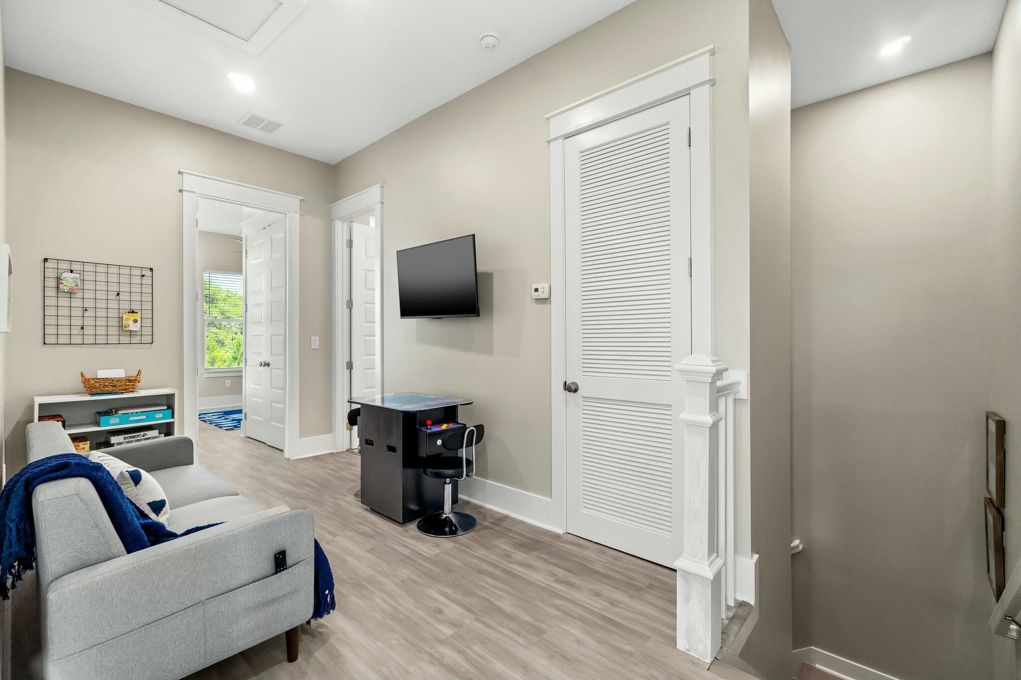 566 Gulfview Circle Santa Rosa Beach, FL 32459 - Photo 21 of 38 a living room with furniture and a flat screen tv