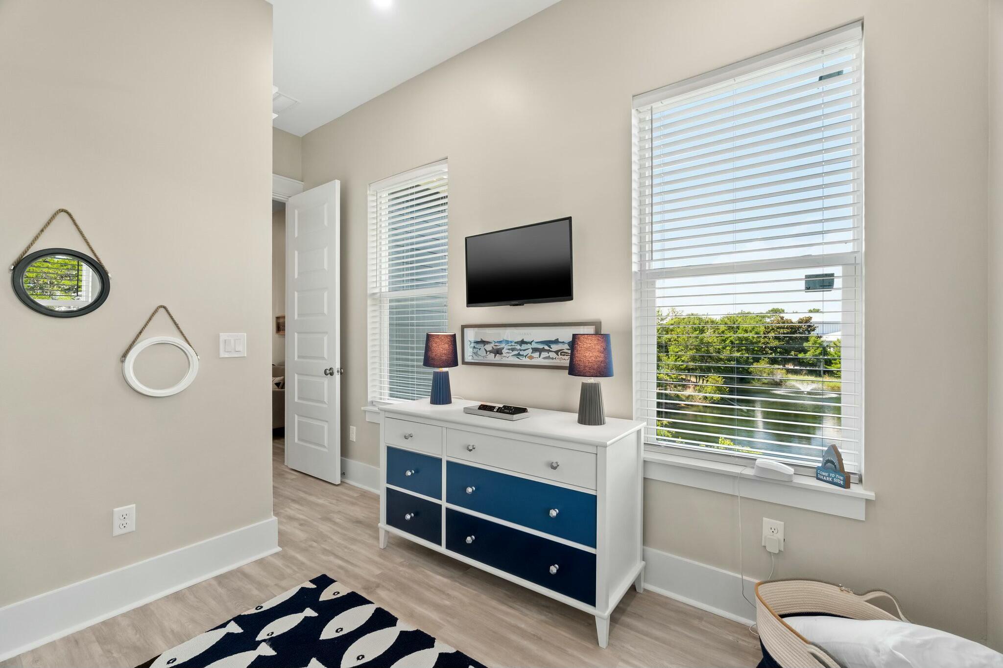 566 Gulfview Circle Santa Rosa Beach, FL 32459 - Photo 24 of 38 a room with a couch and a flat screen tv