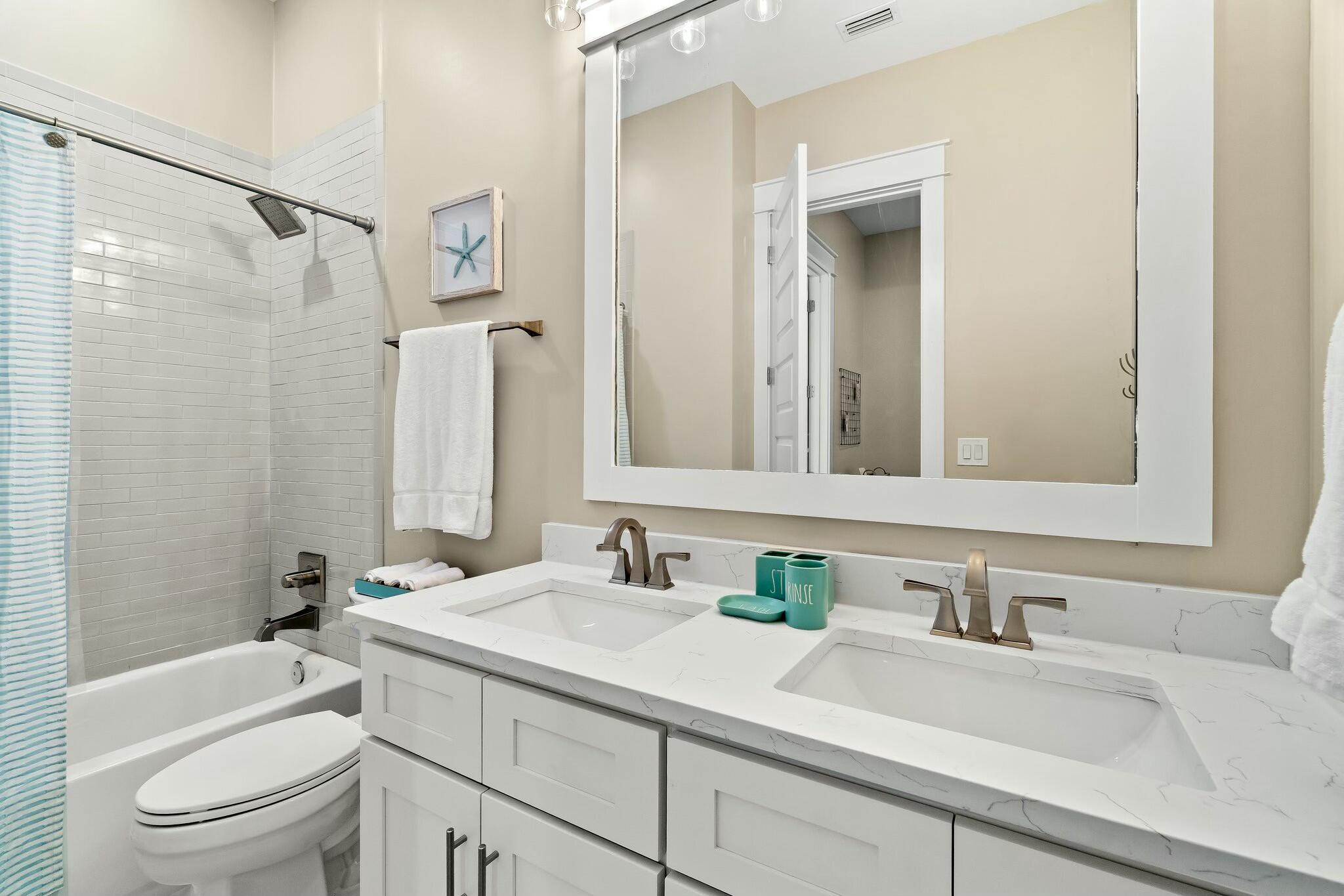 566 Gulfview Circle Santa Rosa Beach, FL 32459 - Photo 25 of 38 a bathroom with a sink vanity granite toilet and shower