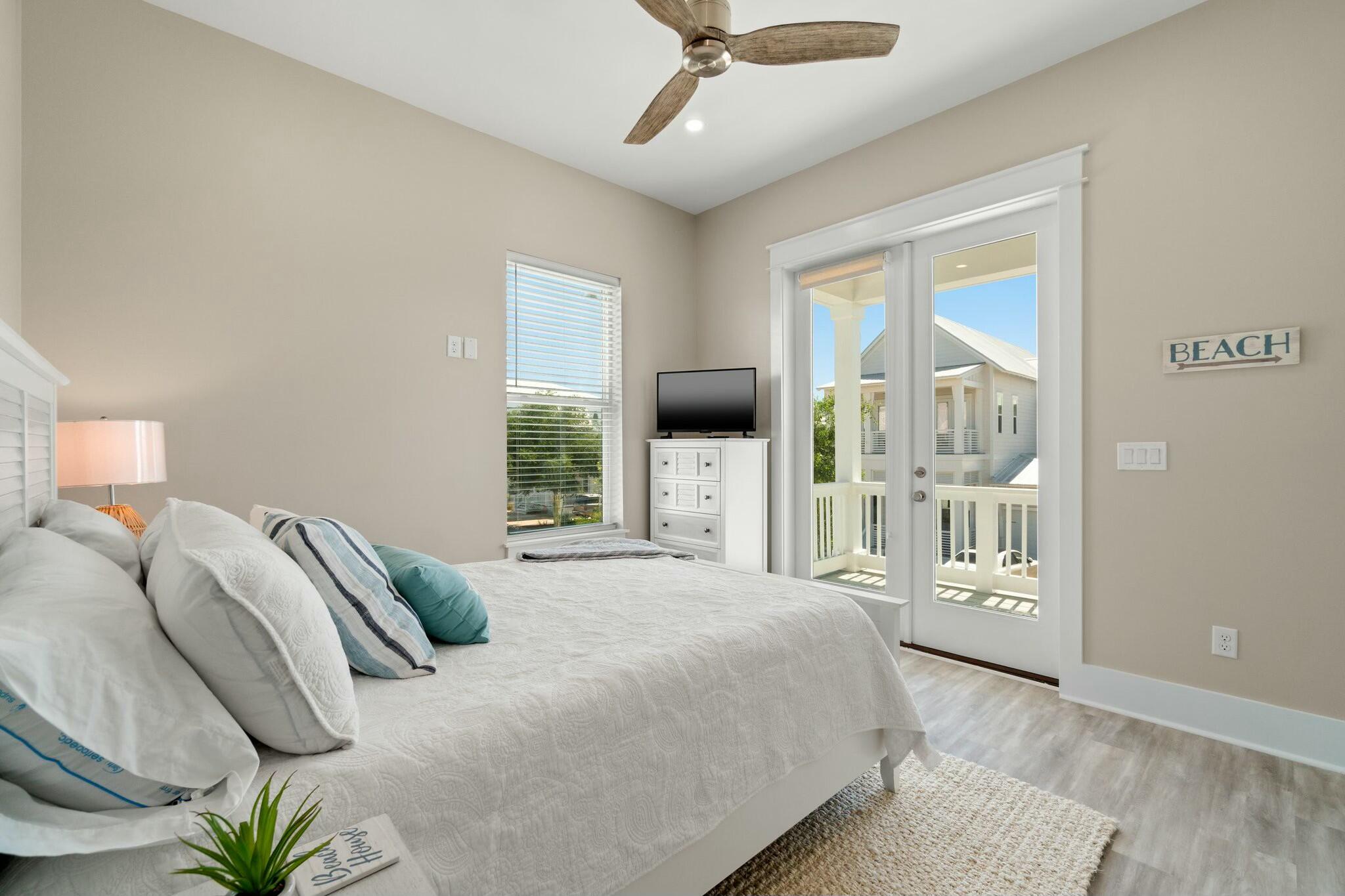 566 Gulfview Circle Santa Rosa Beach, FL 32459 - Photo 26 of 38 a bedroom with a large bed and a chandelier