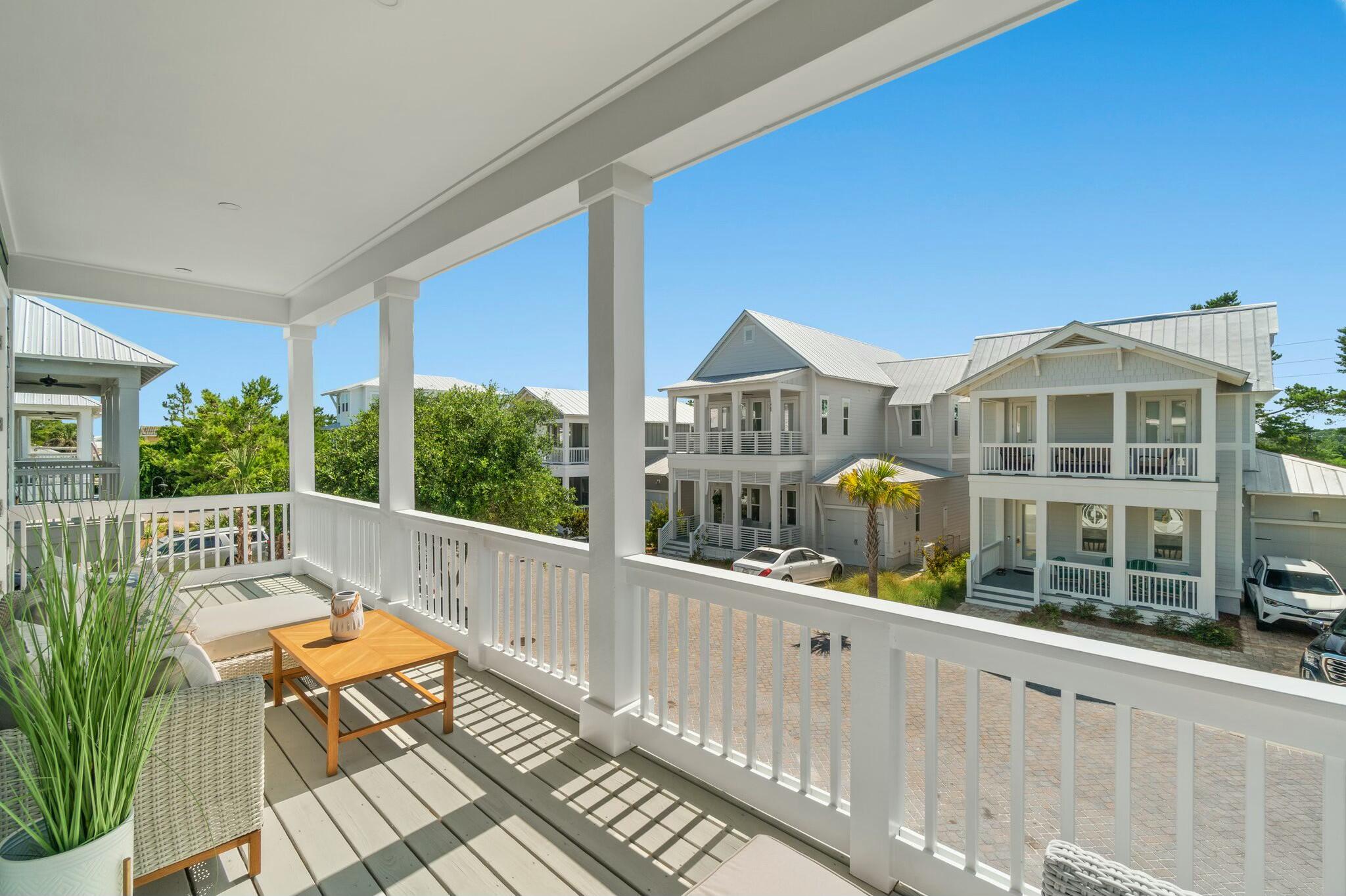 566 Gulfview Circle Santa Rosa Beach, FL 32459 - Photo 30 of 38 a view of a balcony with a floor to ceiling window and wooden floor