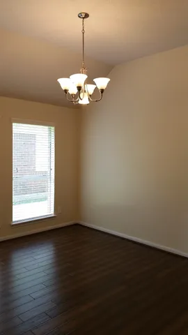 a view of a room with wooden floor and windows