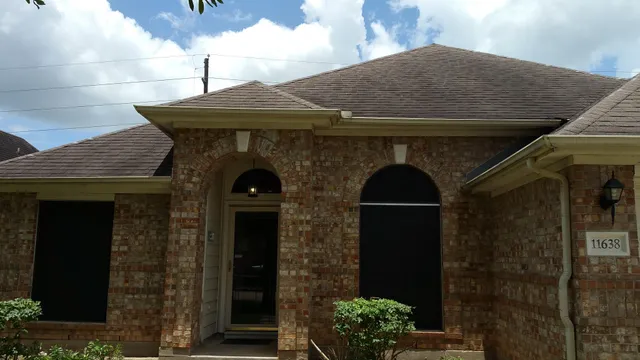 a front view of a house with plants