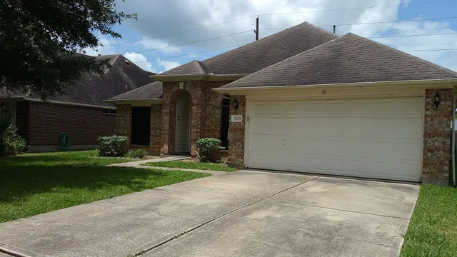 a front view of a house with a garden and yard