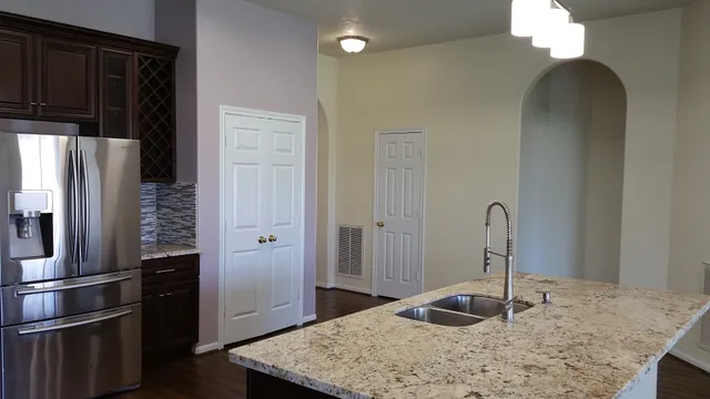 a kitchen with a refrigerator and a sink