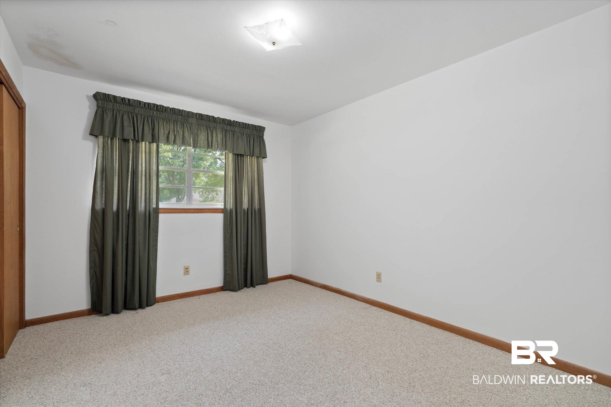423 First Avenue Saraland, AL 36571 - Photo 14 of 20 Spare room with light colored carpet and baseboards