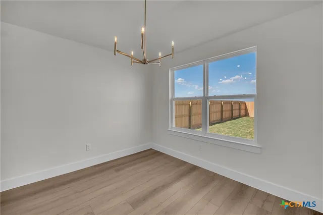 an empty room with a empty space and windows