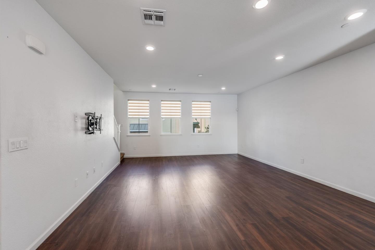 6914 Geyserville Street Dublin, CA 94568 - Photo 14 of 43 an empty room with wooden floor and windows