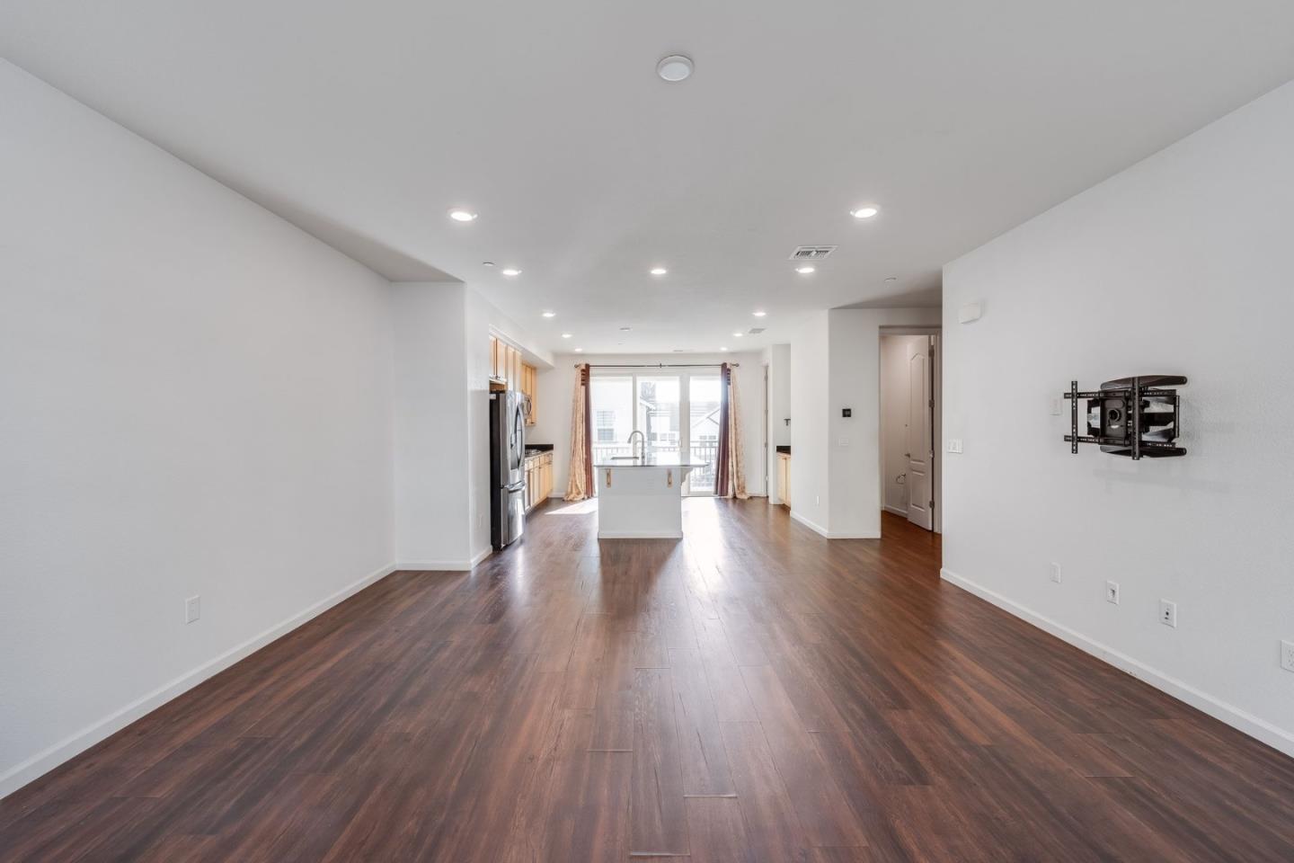 6914 Geyserville Street Dublin, CA 94568 - Photo 15 of 43 a view of a big room with wooden floor and windows