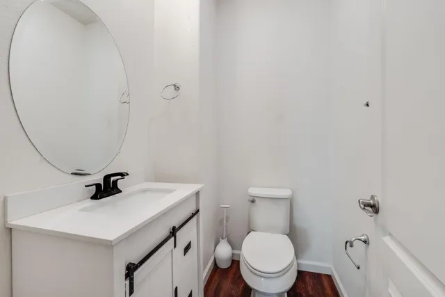 a bathroom with a sink a toilet and a mirror